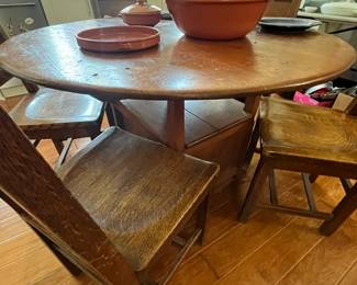 an early round tilt top English tavern table and a set of mission oak dining chairs