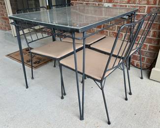 Metal patio table and chairs with plexiglass top