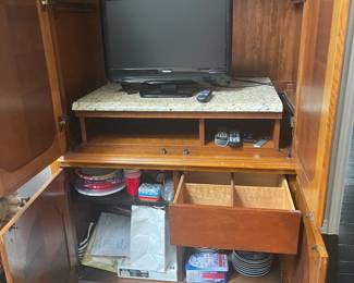 Interior of burled walnut armoire. Also small TV.