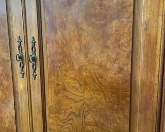 Close up of burled walnut armoire.