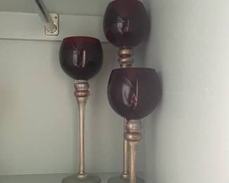 Tall burgundy and gold candle holders.