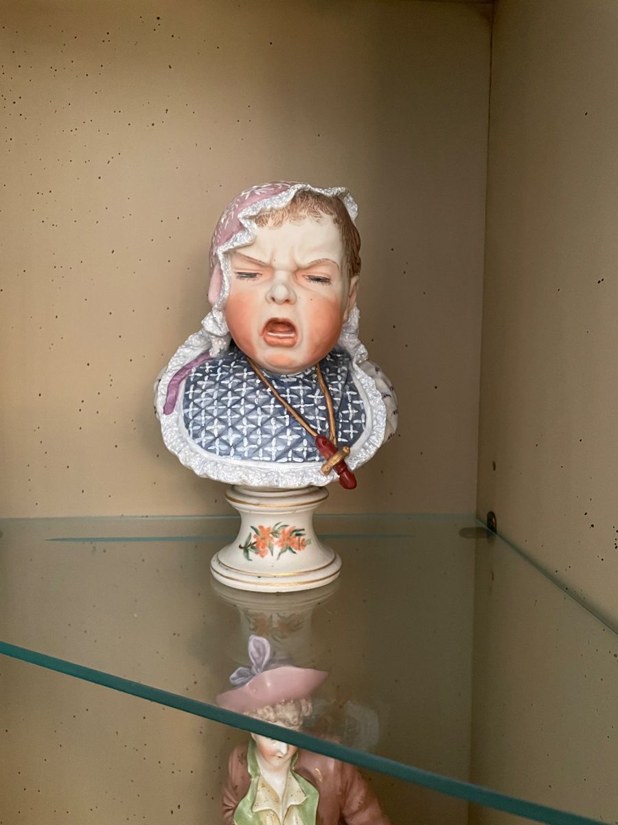 Bisque Handpainted Sad Baby on Stand 