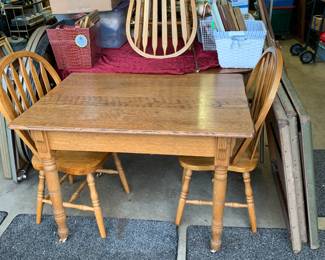 Solid Oak table with 10 inserts and 4 chairs