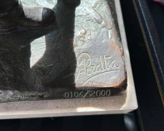 Metal Sculpture of Couple Walking in Rain by Andres Peralta