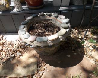 One of 3 rock covered planters