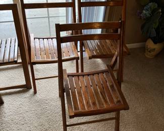 Vintage wood folding chairs — one of two sets of three chairs.