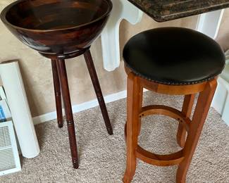 Large wood bowl with stand (left in photo); stool by Chicago Stool & Chair.