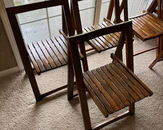 Vintage wood folding chairs — one of two sets of three chairs.