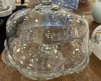 several glass cake stands and covers