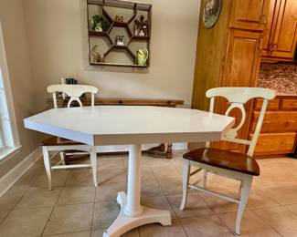 White octagonal table and one pair of chairs.