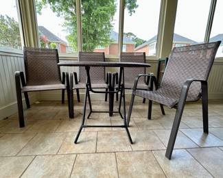 Round glass top patio table and chairs. Table top details in next picture.