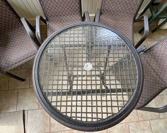 Round glass top patio table.