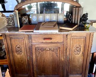 Arts and Crafts carved tiger wood buffet with red marble top, beveled mirror, and bakelite handle, $595