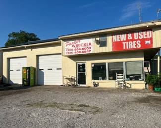 Property comes with 3 metal shop buildings, 1 office w/2  bay garage that includes a car lift, Three bedroom 1.5 bath mobile home. Property offers approx. 256 ft of commercial road frontage sitting on approx. 1.86 acres.  Middle building and mobile home are currently rented as a package for $2,000 per month. 