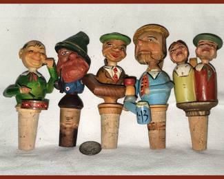 Vintage Carved Wooden Mechanical Wine Stoppers Germany with the last stopper being a kissing couple!