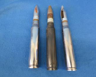 Lot 41. Three 20mm inert rounds including one with a cutaway projectile.