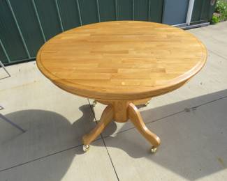 Lot 121. 42" round oak table on castors in excellent condition