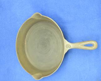 Lot 496. Cast iron 11 3/4" Lodge skillet with a small crack by the handle