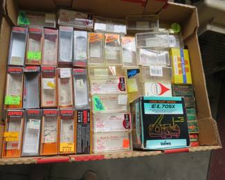 Lot 31. Empty fishing lure boxes, an empty reel box, and empty .22 shell boxes.