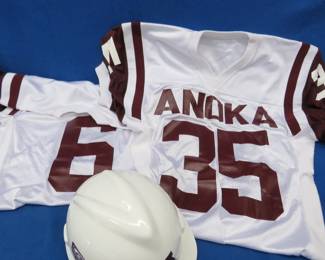 Lot 269. Two Anoka football jerseys (large and medium) and an Anoka hard hat