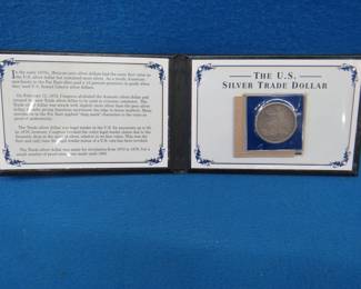 Lot 24. 1877 US Trade silver dollar in a presentation case. No chop marks.