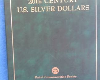 Lot 429. 20th Century US Silver Dollar booklet containing five silver dollars