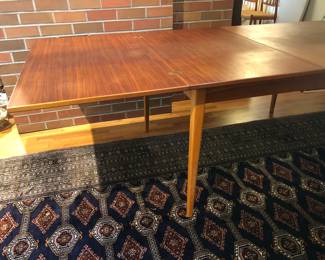 DUX dining table with both leaves extended. Extension at each end folds out from center (As shown: 95"L, 39.5"W, 28.5"H)