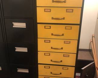 7-drawer yellow & black metal cabinet + 2 black Hon 4-drawer file cabinets