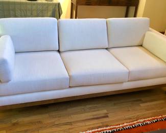 7 ft. white sofa with wooden frame, purchased from Del-Teet in 2017. In GREAT condition! (84”L, 34"D, 26"H. Cushions extend 6" above back, seat is 18” high)