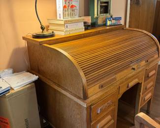 Gorgeous antique roll top desk. “Bruno” task table lamp from Rejuvenation, new in box. Homeowner studied architecture and was a professor of historic preservation, large collection of items pertaining to architecture around the home. Books, decorative items, framed prints noting architectural detail, miniatures, architectural salvage pieces, etc. Desk, 50x32x43"