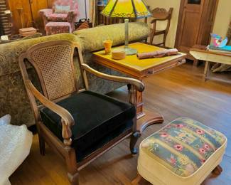 One of two caned chairs with contemporary black velour upholstery. Antique 6 panel slag glass lamp by Miller Lamp Co. Excellent needlepoint footstool, just gorgeous! On table is an antique embossed leather document quiver. Table, 23x23x27"

