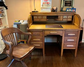 Gorgeous antique roll top desk and a&nbsp;stunning antique oak banker’s chair. Homeowner studied architecture and was a professor of historic preservation, large collection of items pertaining to architecture around the home. Books, decorative items, framed prints noting architectural detail, miniatures, architectural salvage pieces, etc. “Bruno” task table lamp from Rejuvenation, new in box. Desk, 50x32x43"