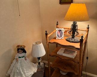 In love with this antique bamboo shelf, it is fragile. And make sure to see the metal art nouveau lamp <3. Collection of vintage Madame Alexander dolls&nbsp;