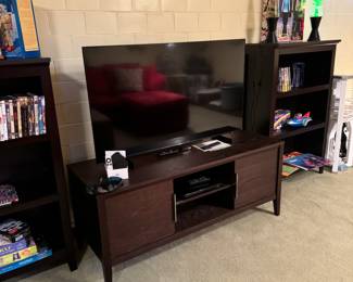 Nice Samsung 50” TV. Beautiful media stand and shelving too!