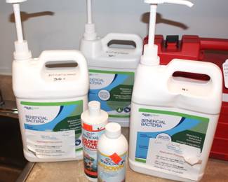 Gallon jugs of beneficial bacteria for fish ponds.