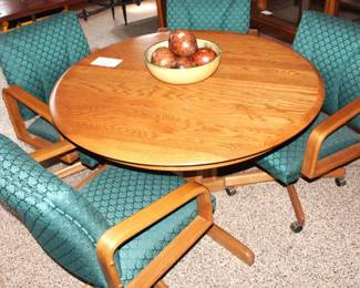 Set of four arm chairs on rollers. $100.00. 48" round oak table w/24" leaf. $100.00.
