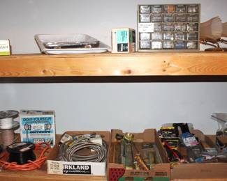 Variety of electrical wiring, plumbing supplies, hand tools.