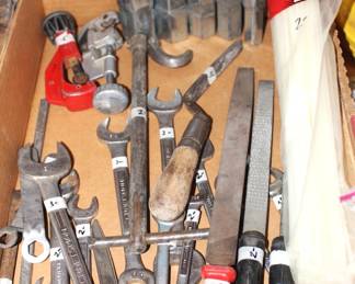 Wrenches, files and plumbing supplies.