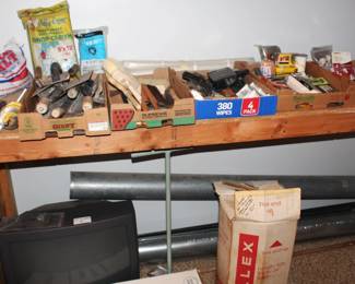 Variety hand tools, painting, duct pipe, and roll of white aluminum finish trim.