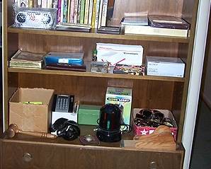 Cabinet w/ romance paperbacks, etc...