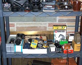 Assorted cameras and lenses: Olympus, Exacta, Polaroid folding land camera, etc...