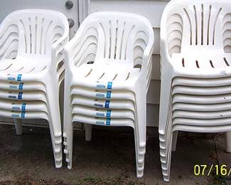 Stacks of resin lawn chairs (some are new)