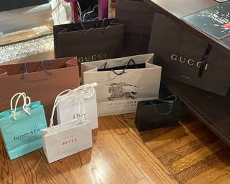 Designer shopping bags from Tiffany & Co., Gucci, Pucci, Burberry, Dior, and Louis Vuitton.