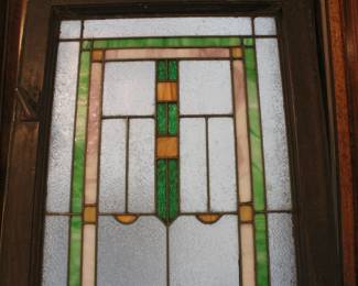 Detail of one of the three matching leaded glass windows, 57" tall and 19 3/4" wide, with original locking brass slides still attached.