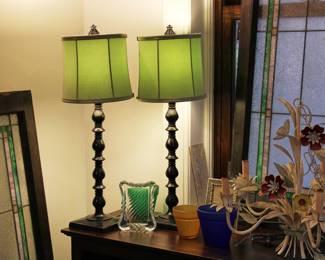 Pair of metal table lamps with green lampshades shown with crystal photo frame and vintage flower Tole five-light chandelier