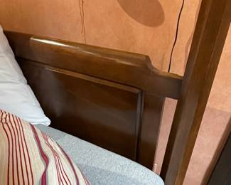 Headboard detail of four poster Queen sized bed