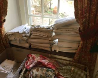 Stacks of French nice heavy linen sheets. So wonderful to sleep in and many are decorated with needlework such as padded embroidery