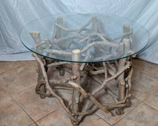 Lot 745: Artisan made branch table with glass top; measures 19 " high x 27.5 " diameter