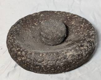 Lot 743: Metate and grinding stone; measures 8 " diameter