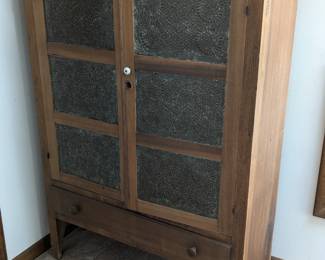 Lot 137: Antique pie safe with punched tin doors, shelves behind doors and single drawer below; measures 56.5 " high x 40 " wide x 16 " deep